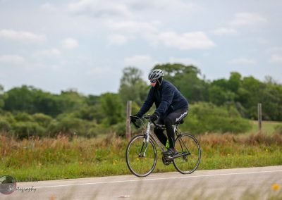 Cruising on an electric bike through scenic Texas countryside, promoting Bluebonnet Express eco-friendly transportation.