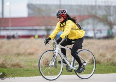 Comfortable women cycling in rain gear on a bike ride.