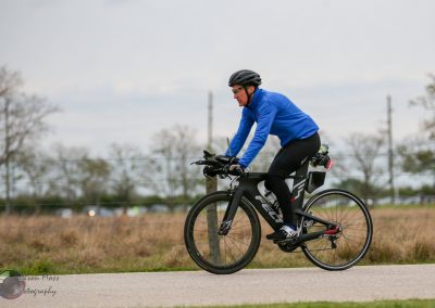 Efficient Bluebonnet Express electric bike ride through open landscape with cyclist in motion.