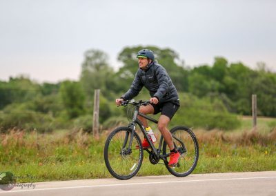 Vibrant outdoor cycling on a scenic trail with a man wearing a helmet and athletic gear.