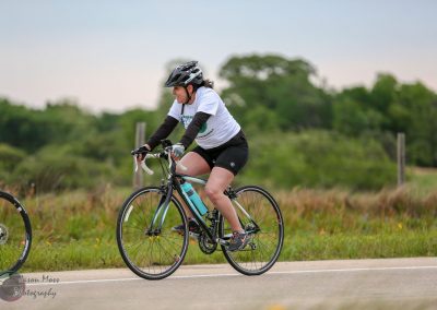 Rider on a Bluebonnet Express bicycle during outdoor cycling event on scenic trail.