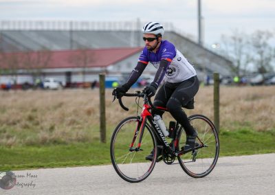 Cyclist riding a road bike on a trail during Bluebonnet Express event, emphasizing outdoor biking and cycling race.