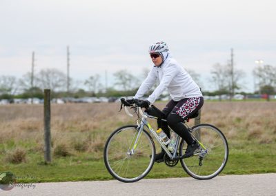 Comfortable female cyclist riding a bike on a scenic outdoor trail, promoting Green Bike Transportation.
