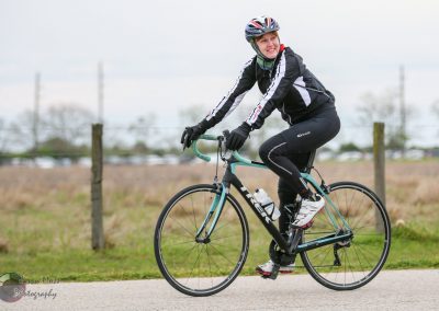 Vegan cyclist riding a Trek bike outdoors on a cloudy day for Bluebonnet Express.