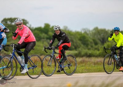 Vibrant cyclists participating in the Bluebonnet Express cycling event on a scenic route in Texas.