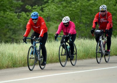 Vegan bikers riding together on a scenic trail, promoting outdoor activity and environmental awareness.