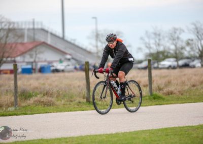 Velo rider on Black and Red Bike during daytime outdoor cycling event or training session.