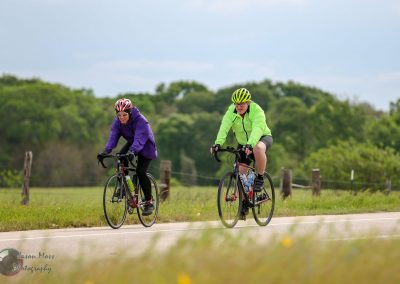 Vibrant cyclists enjoying a scenic ride on the Bluebonnet Express trail in Texas.
