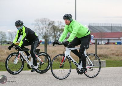 Velo riders in bright jackets riding along a path,# featuring "Bluebonnet Express" branding for cycling event.