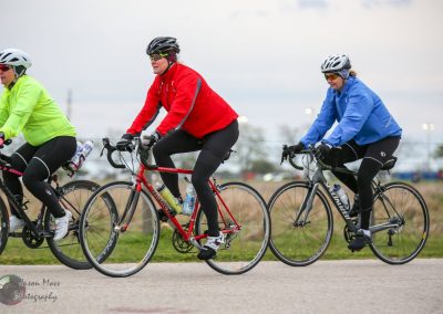 Cyclists riding together during Bluebonnet Express cycling event on a scenic outdoor trail.