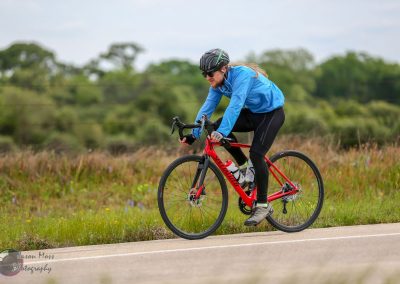 High-performance road cyclist on a scenic rural route, showcasing biking sports and outdoor adventure.