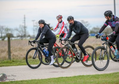Vibrant group of cyclists riding on scenic trail, showcasing outdoor adventure and fitness.