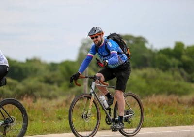 Vibrant cyclist riding the Bluebonnet Express bicycle trail in Texas, enjoying scenic outdoor cycling adventure.