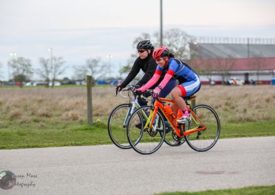 Bright blue and orange bikes on a scenic trail with cyclists enjoying Bluebonnet Express ride.
