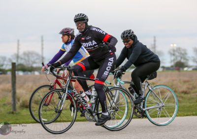 High-performance cyclists riding together in Bluebonnet Express cycling event, showcasing teamwork and athleticism.