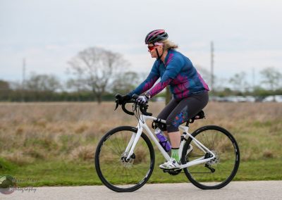 Lightweight electric bike during Bluebonnet Express ride, woman cycling through scenic Texas landscape.