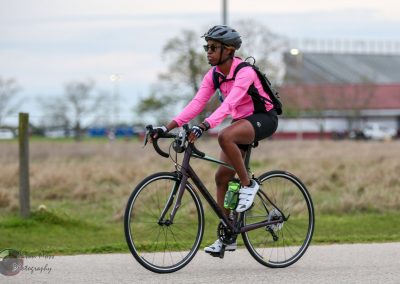 Bike riding with Bluebonnet Express bicycle, outdoor cycling activity, athletic biking event.