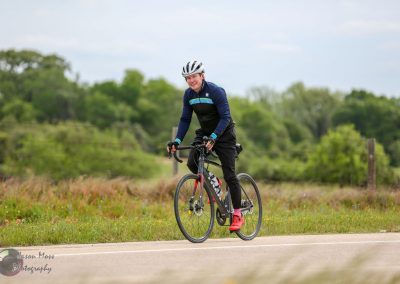 Bright cyclist enjoying a scenic ride on Bluebonnet Express bike trail in Texas.