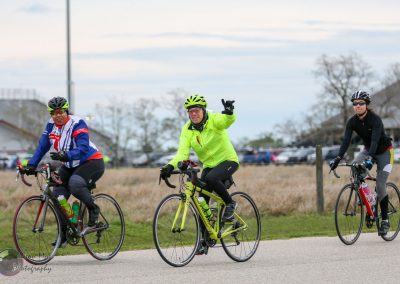 Bright cyclists enjoying the Bluebonnet Express bike ride on a scenic trail.