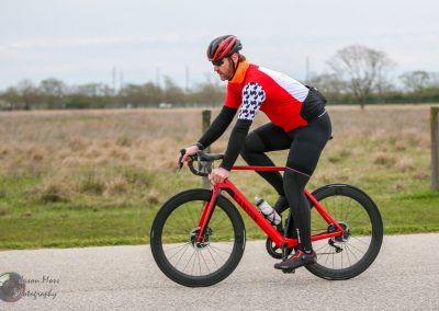 Rider on Canyon bluebonnet express electric bike on paved trail during outdoor cycling event.