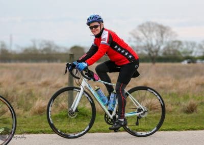 Vibrant cyclist riding a mountain bike on open trail during outdoor ride.