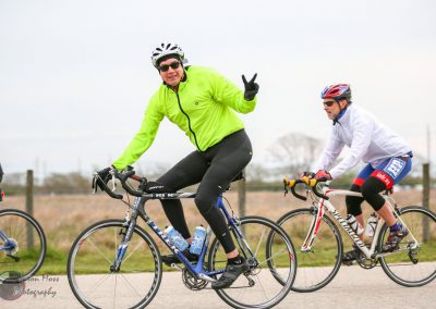 Bright green cyclist jacket on Bluebonnet Express bike ride in Texas, scenic outdoor cycling event.