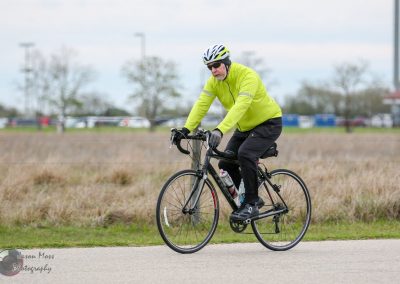 Comfortable cyclist enjoying scenic road biking with Bluebonnet Express bike service.