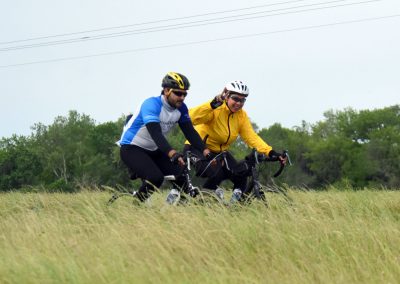 Vibrant cyclists enjoying a scenic ride on Bluebonnet Express trail in Texas.