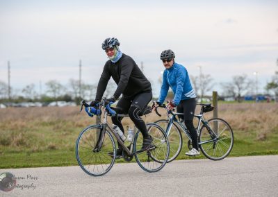 Comfortable cycling at Bluebonnet Express event in Texas, featuring two cyclists on road bikes.