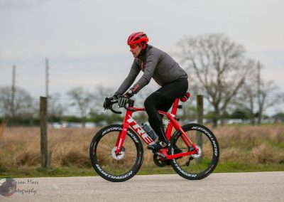 Red Trek bicycle on outdoor scenic trail for Bluebonnet Express cycling event.