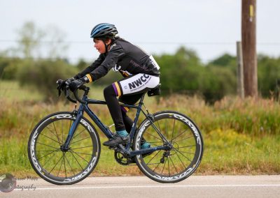 Kids cycling race on Bluebonnet Express bike trail, showcasing youth sports and outdoor activity.
