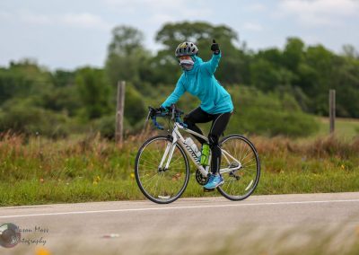 Bright blue cycling jacket and helmet on a mountain bike during a scenic outdoor ride.