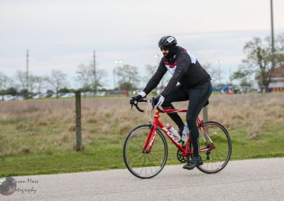 Smooth road biking on a red bike during daytime.