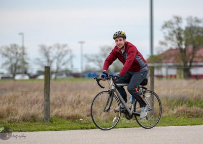 Comfortable cyclist riding a bike on a scenic outdoor trail, promoting bike safety and eco-friendly transportation.