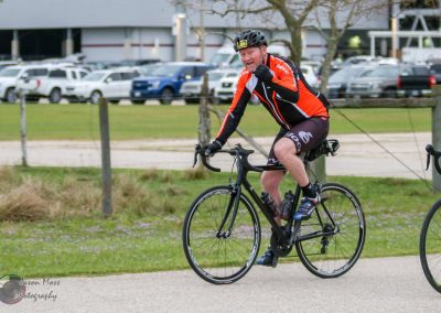 Cyclist riding a road bike outdoors during Bluebonnet Express event in Texas.