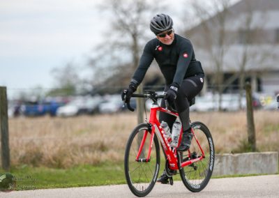 Vibrant red bike on a cycling tour with Bluebonnet Express, outdoor landscape, winter season, fast-paced ride.