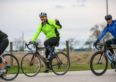 Bright green cycling jacket on rider during Bluebonnet Express bike ride event.