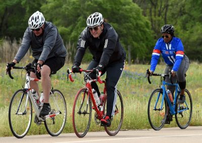 Brightly colored cyclists riding on a scenic trail in Texas for Bluebonnet Express.
