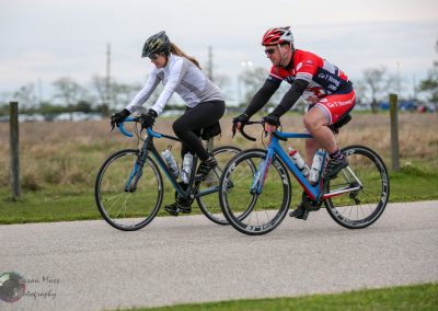 Bright blue and red bicycles during Bluebonnet Express cycling event with male and female riders.