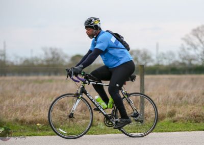 Vegan cyclist riding a mountain bike along a scenic trail in nature.