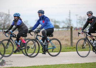 Brightland Bluebonnet Express cycling event with riders in colorful gear and helmets.