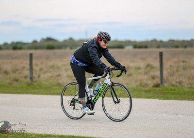 Rider enjoying scenic bike ride on a Cervélo road bike in open countryside.