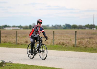 Vermilion Texas Bluebonnet Express cyclist riding bike outdoors on pavement during daytime.