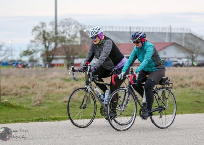 Cyclists riding bikes outdoors in a scenic park setting.