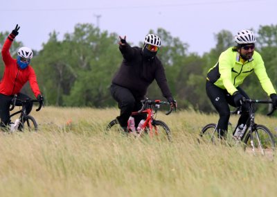 Vibrant cyclists enjoying a ride on the Bluebonnet Express trail through scenic Texas countryside.