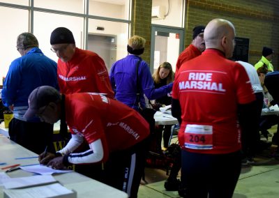 Event volunteers registering at the Bluebonnet Express bike race registration table.