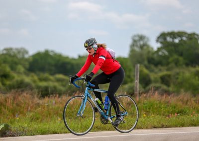 Bright red cycling jacket worn during Bluebonnet Express bike ride for outdoor exercise and scenic ride.