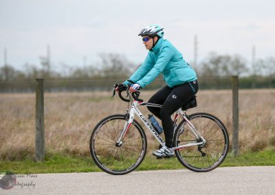 Cyclist practicing outdoor biking on a scenic trail with Bluebonnet Express bike.