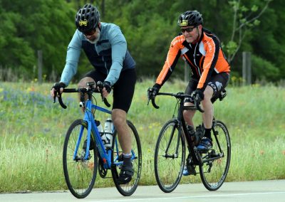 Older men biking on a scenic trail, enjoying outdoor cycling adventures.