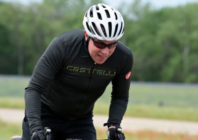Vibrant cyclist enjoying a ride on the Bluebonnet Express trail in Texas, highlighting outdoor biking adventure and scenic routes.